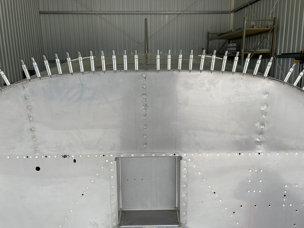 The upper forward fuselage attached permanently using rivets
