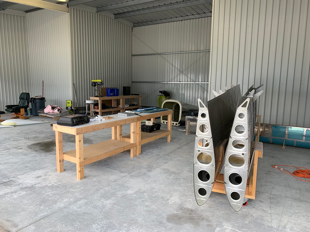 Airplane parts and tables in a hangar