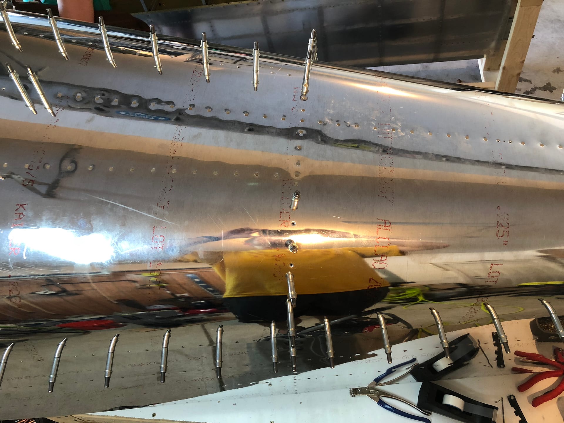 Making our way down the top aft empennage skin.